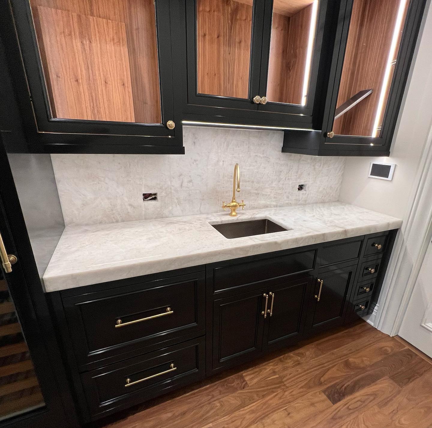 Close view of a pale stone countertop and backsplash
